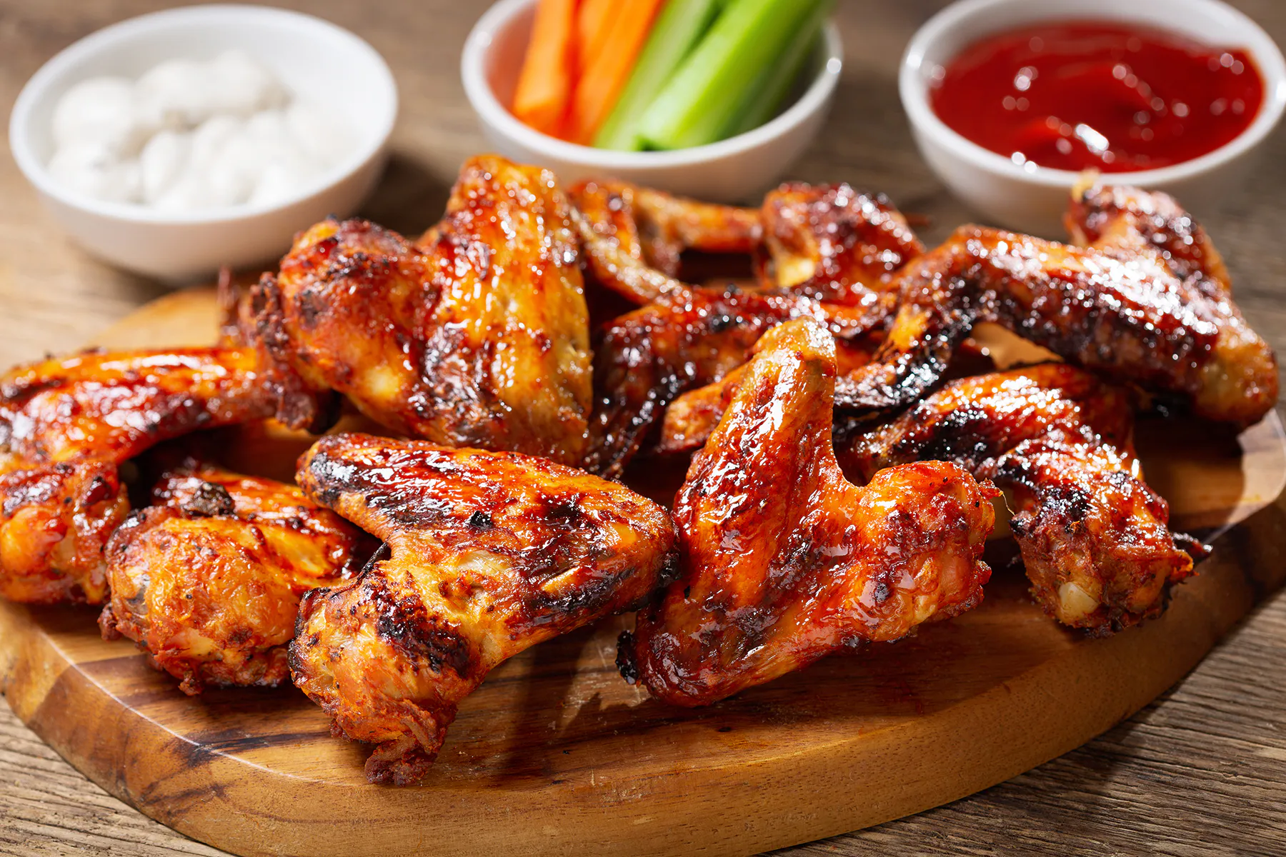 Glazed grilled chicken wings with dipping sauces