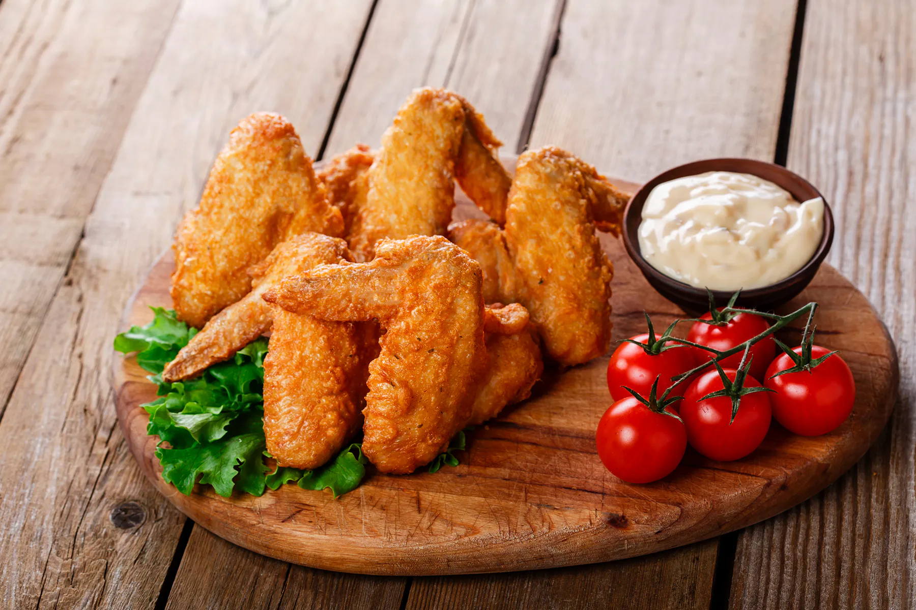 Crispy fried chicken wings with creamy dipping sauce